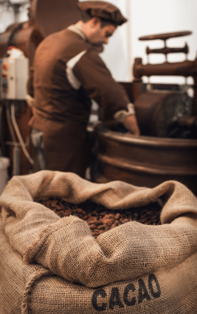 Image of chocolatier with a cacao bag in the forefront