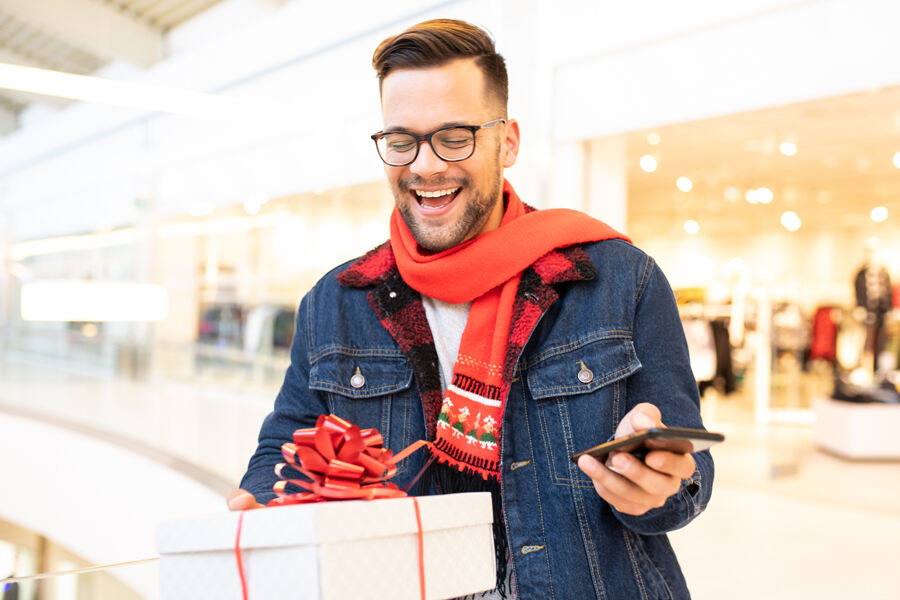 A man stands with a gift box