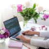 A woman types on her laptop at a desk, embodying the spirit of productivity and celebration for Mother's Day at work