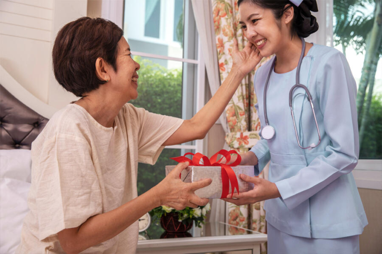 A nurse receives a box of chocolates from a patient as a gesture of gratitude in a hospital setting