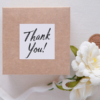 A beautifully wrapped thank you gift box adorned with a ribbon, symbolizing gratitude and appreciation