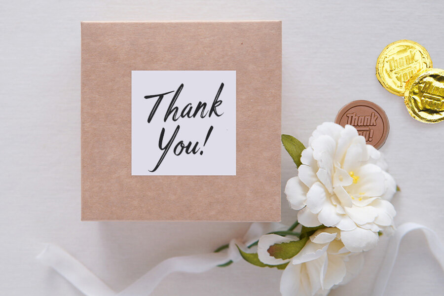 A beautifully wrapped thank you gift box adorned with a ribbon, symbolizing gratitude and appreciation