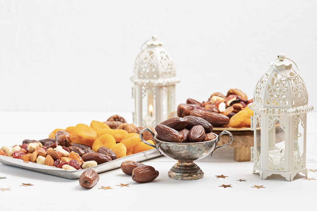 Eid al Fitr holiday spread of nuts and fruit with traditional lanterns