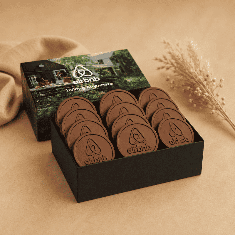 Gift box filled with custom engraved chocolate coins and personalized branded packaging